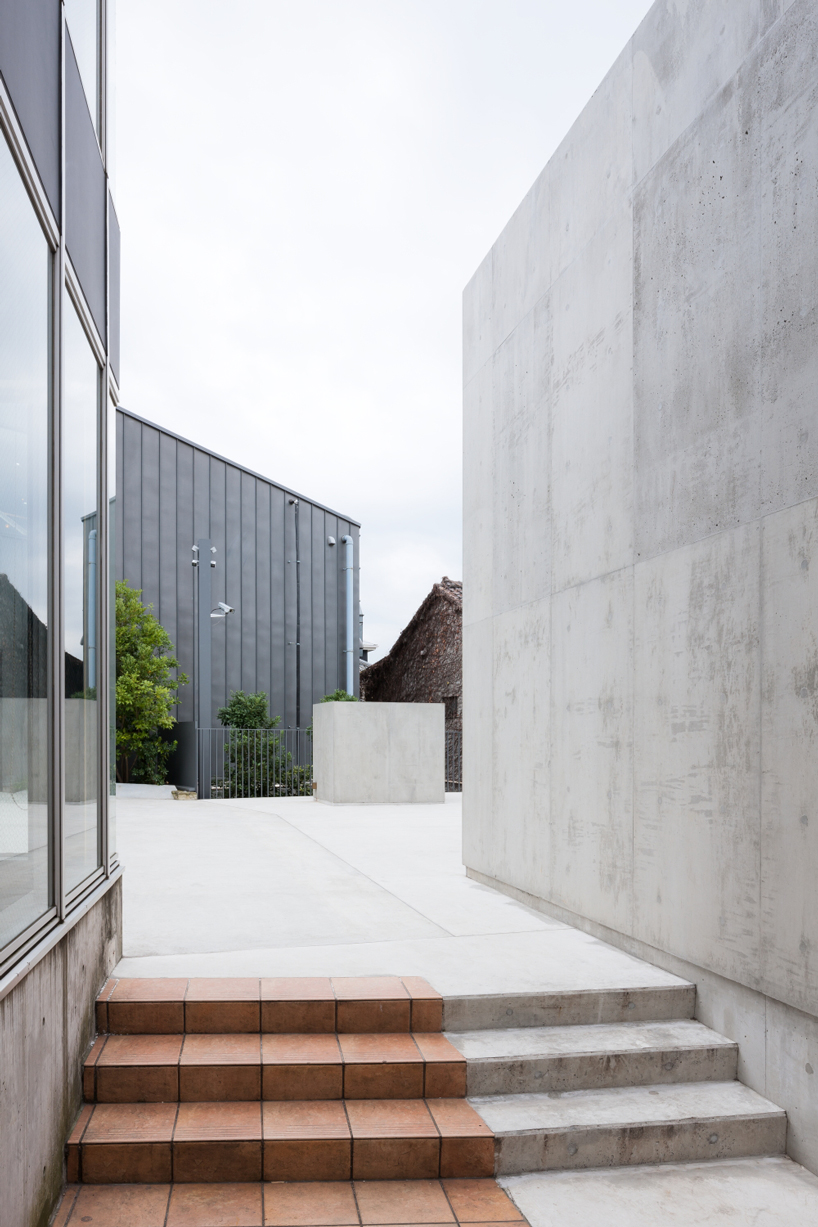 nobuo araki combines three concrete blocks into 'the mass' museum complex in tokyo