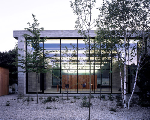 architecture club combines concrete frame with glazed façade for artist's studio in warsaw