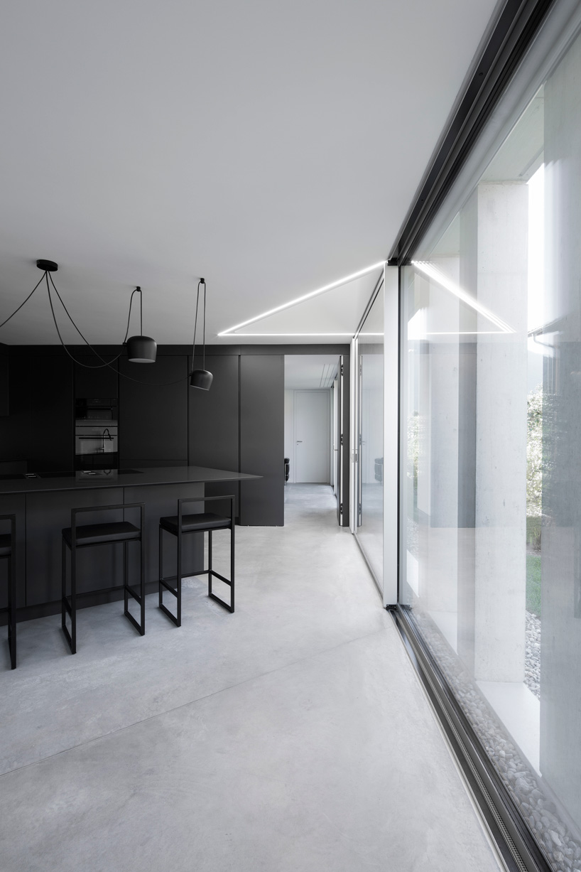 DF_DC concrete villa in comano, switzerland, is conceived as an inhabited wall