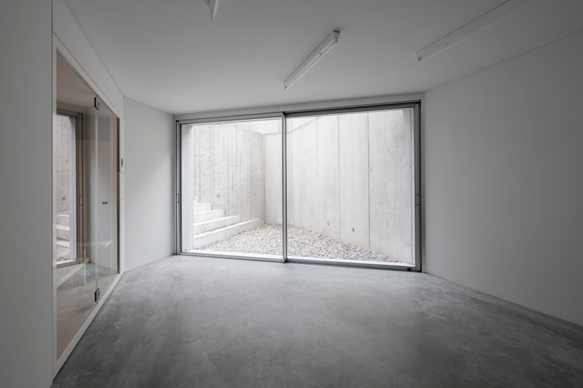 DF_DC's concrete villa in comano, switzerland, is conceived as an inhabited wall