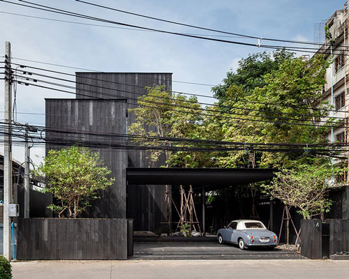 black timber cladding envelops IDIN architects' tranquil office space in bangkok