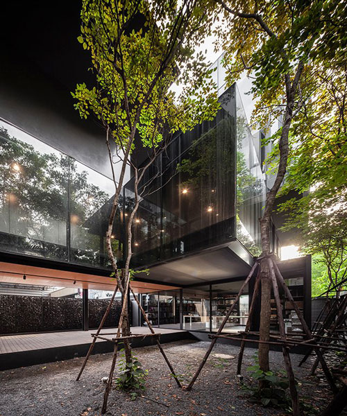 black timber cladding envelops IDIN architects' tranquil office space in bangkok