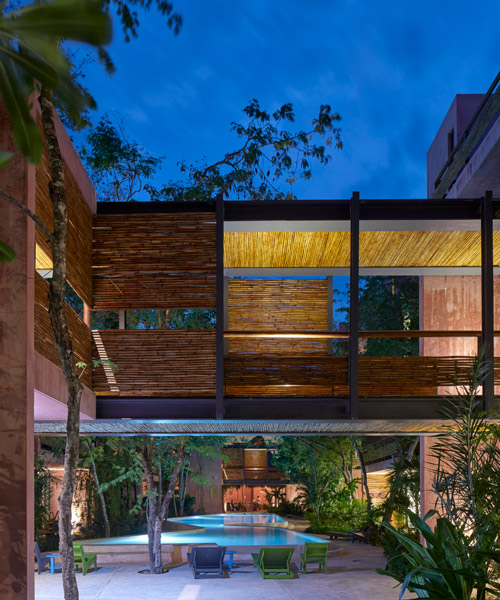 residential complex in mexico colored pink to contrast its lush green surroundings