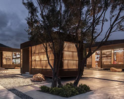 woven timber façades clad a series of box-like pavilions in crete, greece