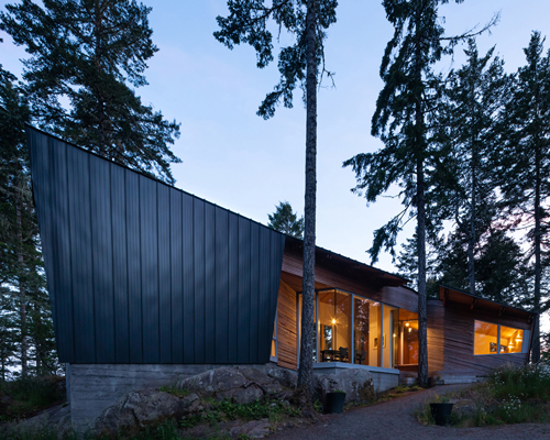 campos studio embeds the sooke house within the forest of a rocky hill in canada