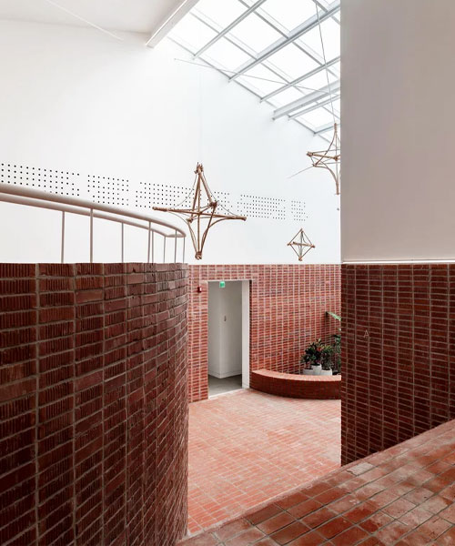 starsis applies red bricks and bamboo sculptures to studio interior in south korea