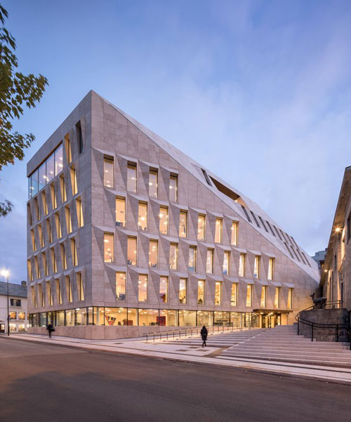 studio ALL's faceted stone facade plays with light on city hall in norway