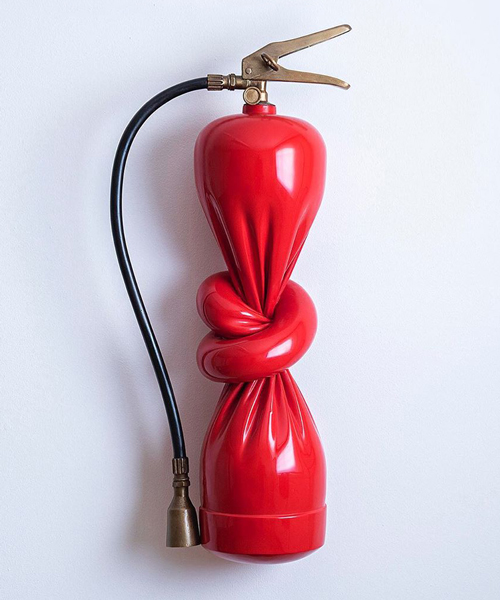 alex chinneck ties a knot in twisted fire extinguisher sculpture