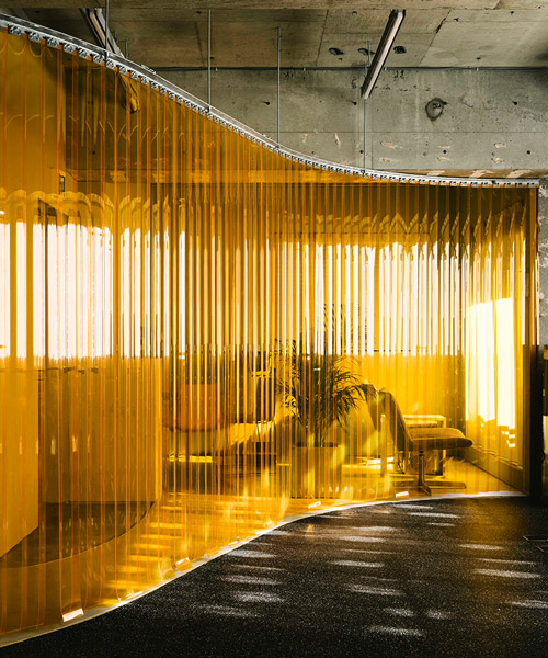 arii irie architects divides gym interiors with an orange vinyl strip curtain in tokyo