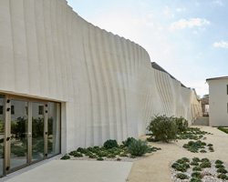 carl fredrik svenstedt adds cellar clad in curving solid stone to delas frères winery in france