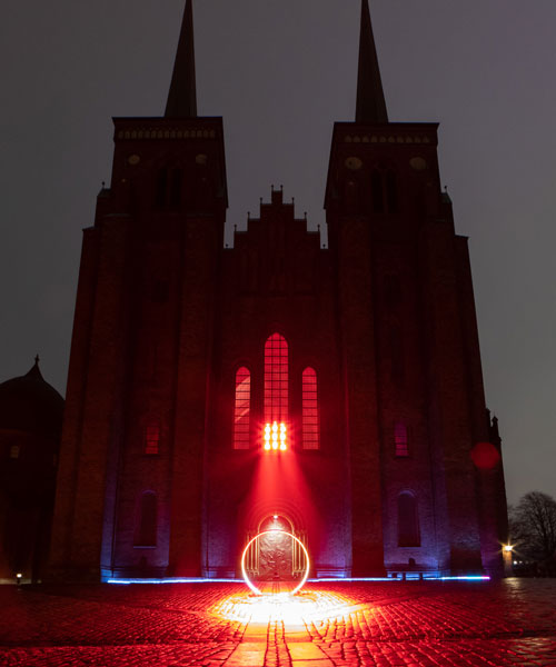 SIIKU's 'LUX NOVA' beams a circle of light outside roskilde cathedral in denmark
