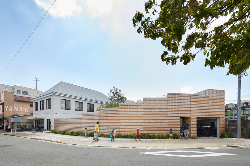  naf architect & design encloses 'small pond' nursery school in tokyo with curved wood façade