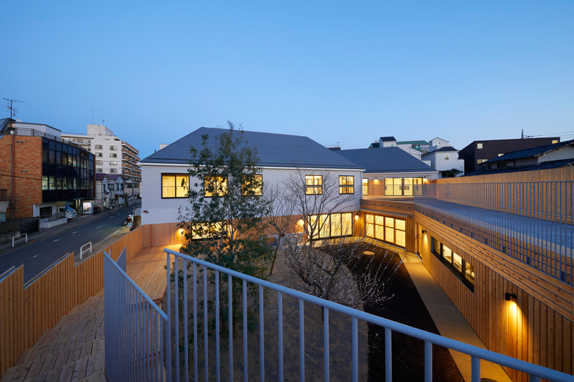 naf architect & design encloses 'small pond' nursery school in tokyo with curved wood façade