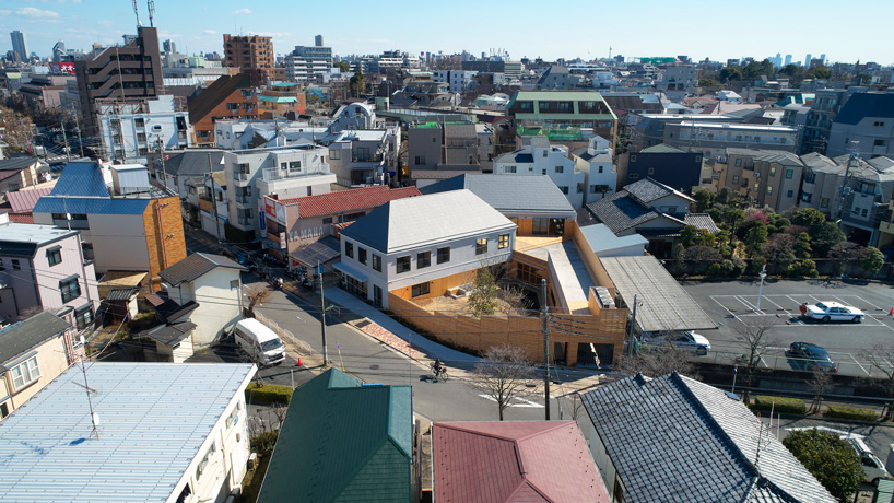  naf architect & design encloses 'small pond' nursery school in tokyo with curved wood façade