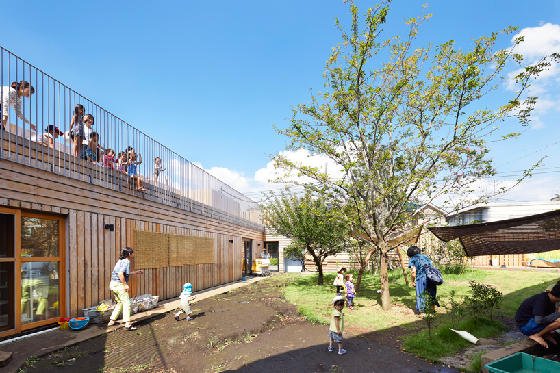  naf architect & design encloses 'small pond' nursery school in tokyo with curved wood façade