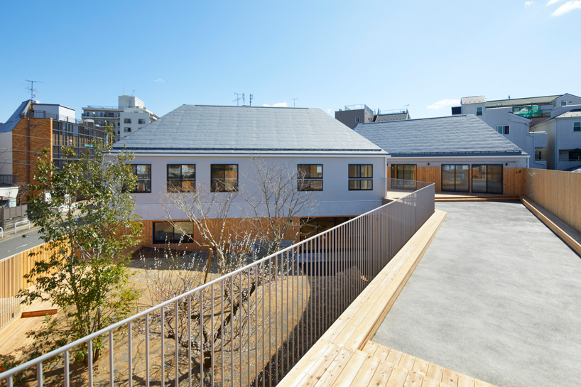  naf architect & design encloses 'small pond' nursery school in tokyo with curved wood façade