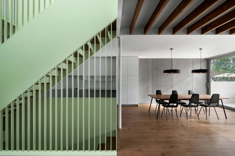 sage green staircase takes center stage in montreal residence renovation by naturehumaine