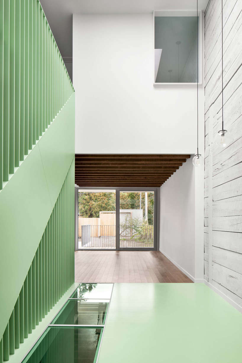 sage green staircase takes center stage in montreal residence renovation by naturehumaine