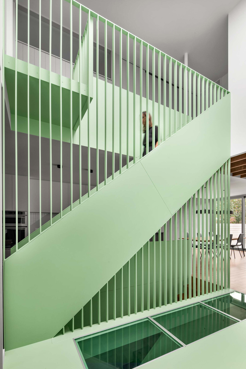 sage green staircase takes center stage in montreal residence renovation by naturehumaine