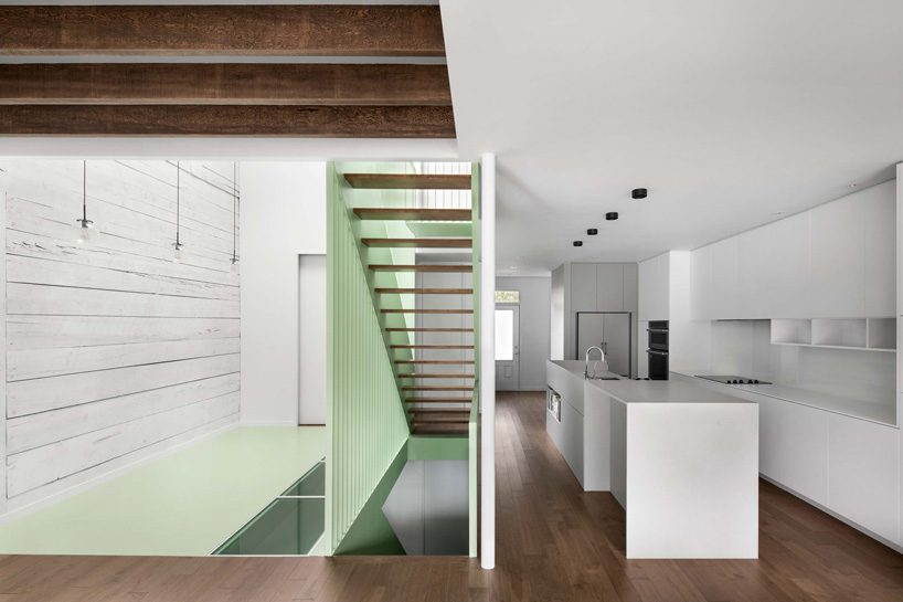 sage green staircase takes center stage in montreal residence renovation by naturehumaine