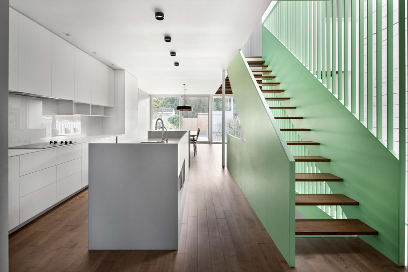 living room with green staircase wall