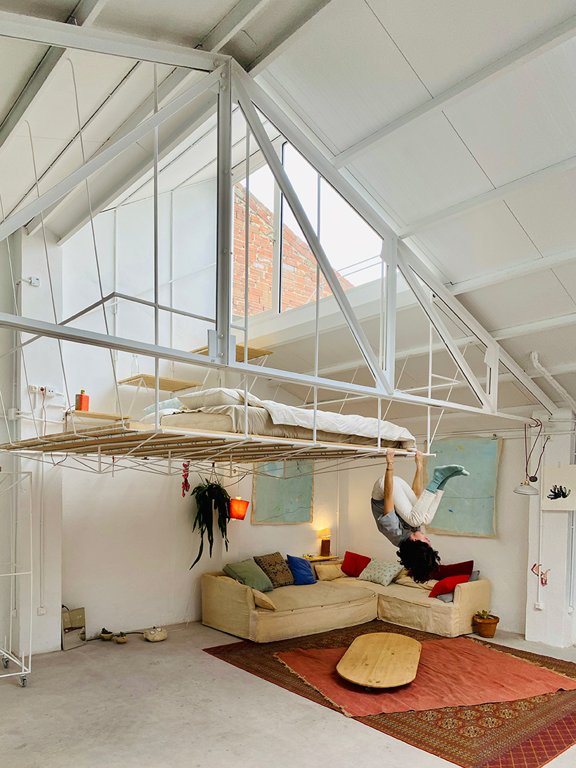 pía mendaro-designed artist's studio in madrid has a bed suspended from its ceiling