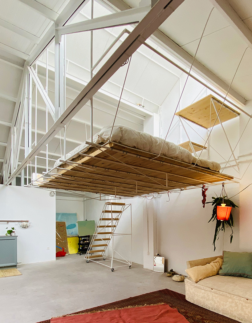 pía mendaro-designed artist's studio in madrid has a bed suspended from its ceiling