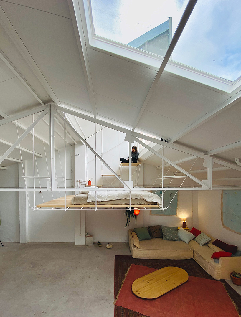 pía mendaro-designed artist's studio in madrid has a bed suspended from its ceiling