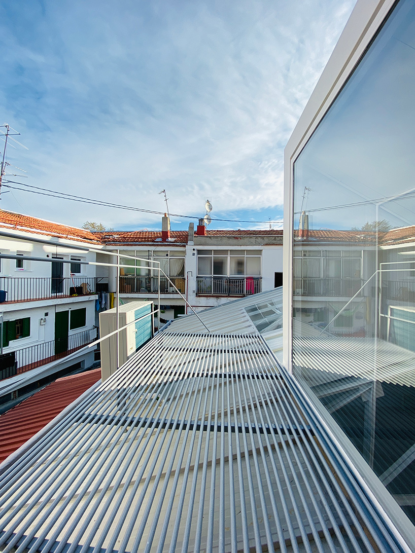 pía mendaro-designed artist's studio in madrid has a bed suspended from its ceiling