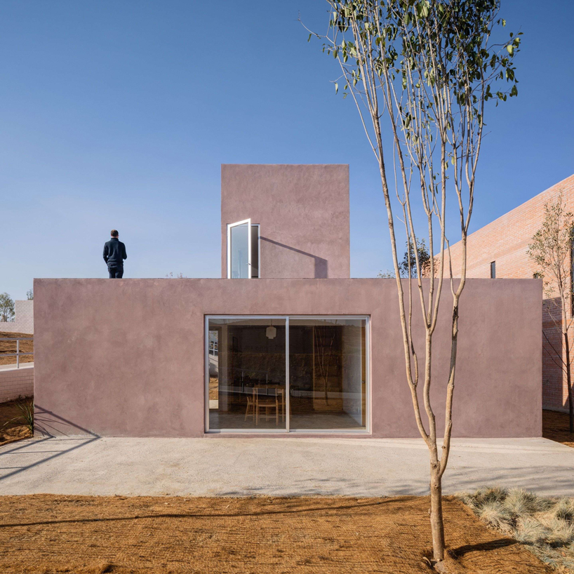 two pink adobe volumes form PPAA's prototype for social housing project in mexico designboom