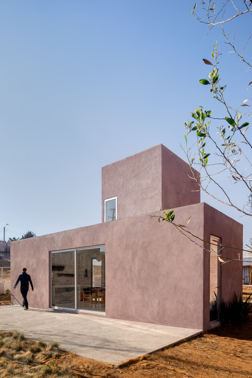 two pink adobe volumes form PPAA's prototype for social housing project in mexico designboom