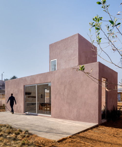 two pink adobe volumes form PPAA's prototype for a social housing project in mexico
