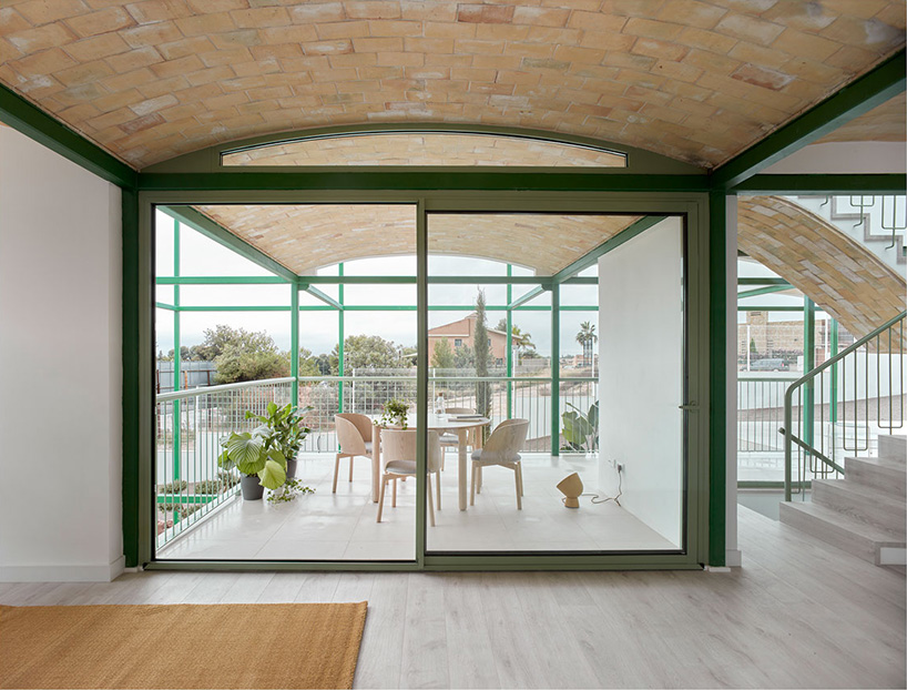 space popular forms valencia's brick vault house with a modular, bright green grid