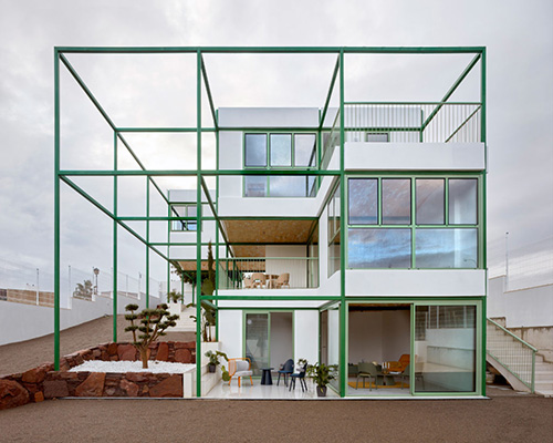space popular forms valencia's brick vault house with a modular, bright green grid