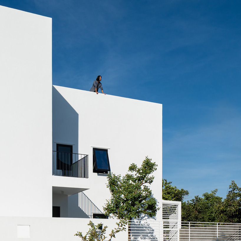 story architecture completes cubic white-hued house for young family in vietnam