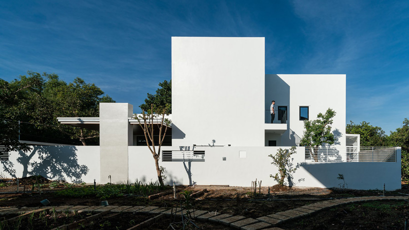 story architecture completes cubic white-hued house for young family in vietnam