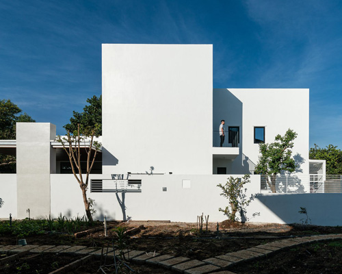 story architecture completes cubic white-hued house for young family in vietnam