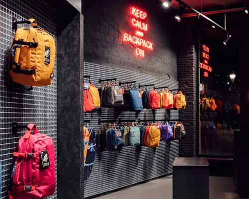 anthracite gray brick and metal grids frame studioapart's backpack store in barcelona