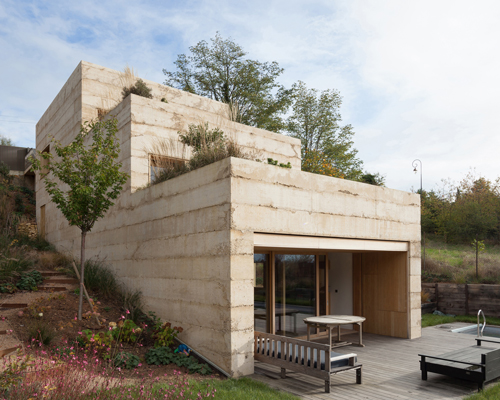 a stepped concrete house by tectoniques architectes emerges from the ground in france
