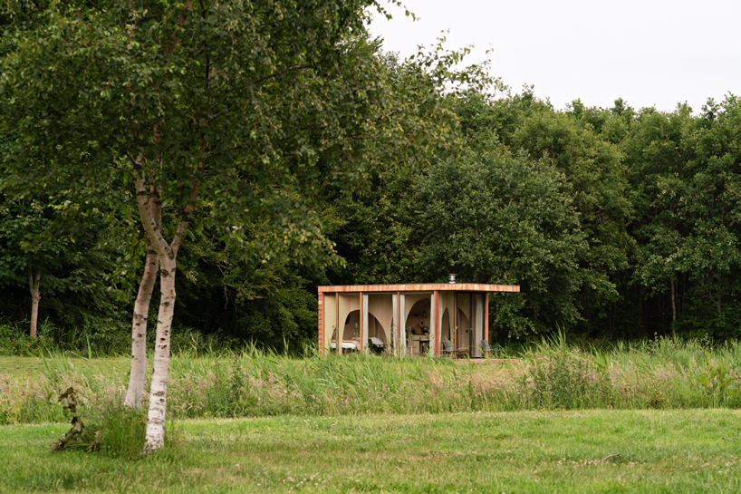 thewaywebuild fills its tiny forest cabin with a network of timber arches