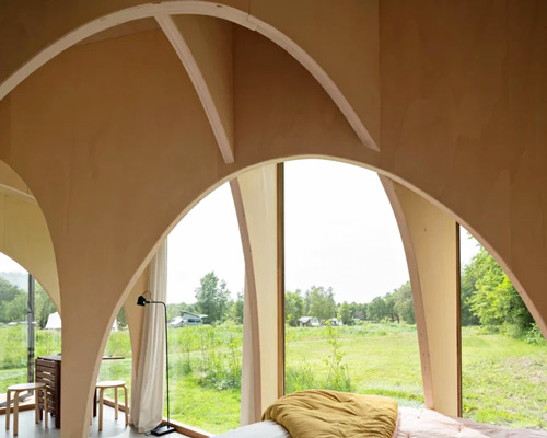 thewaywebuild fills its tiny forest cabin with an expressive network of timber arches