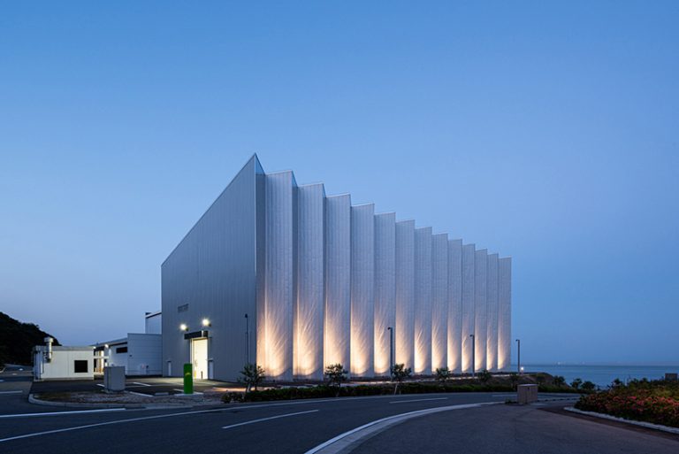 a reflective zig-zag façade clads OHArchitecture's factory in awaji, japan