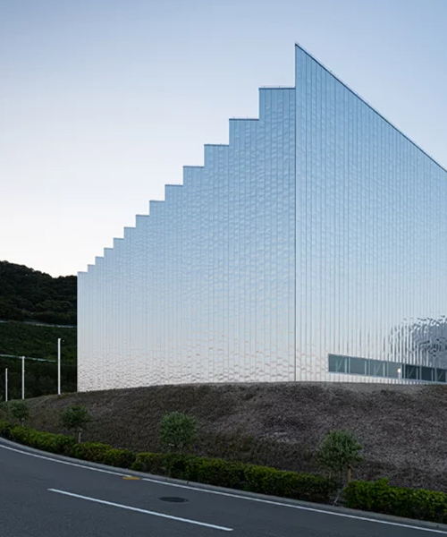 a reflective zig-zag façade clads OHArchitecture's factory in awaji, japan