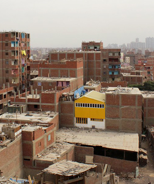 ahmed hossam saafan builds a yellow cultural center in one of cairo's most populated slums