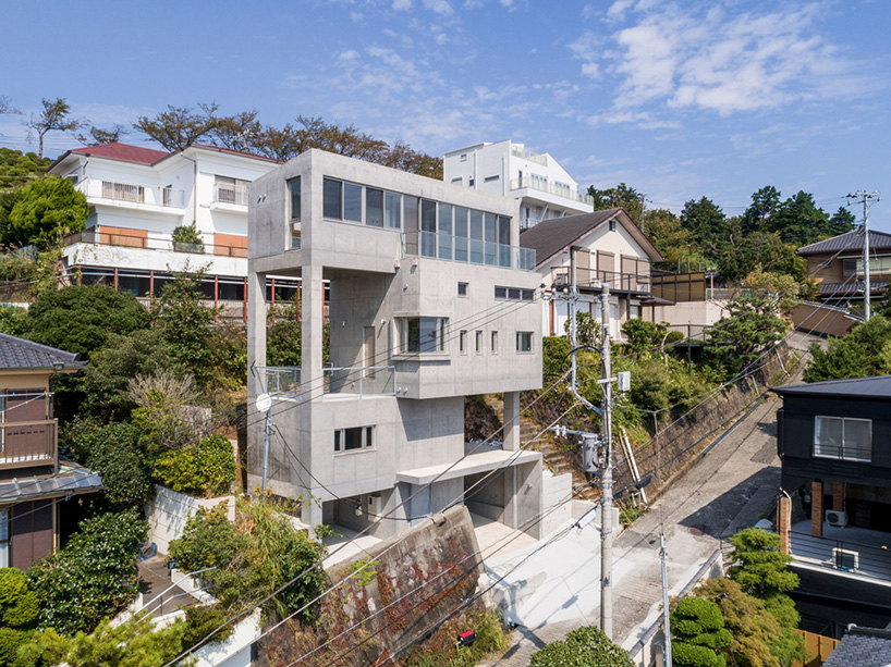 ashida architects sets concrete atami tower house on a steep slope in japan