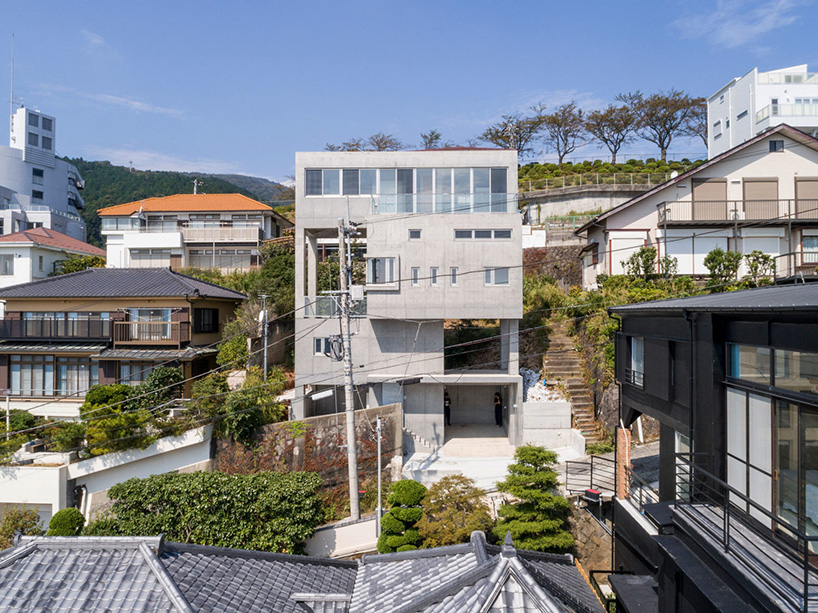 ashida architects sets concrete atami tower house on a steep slope in japan