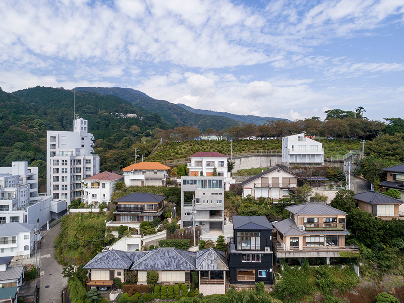 ashida architects sets concrete atami tower house on a steep slope in japan