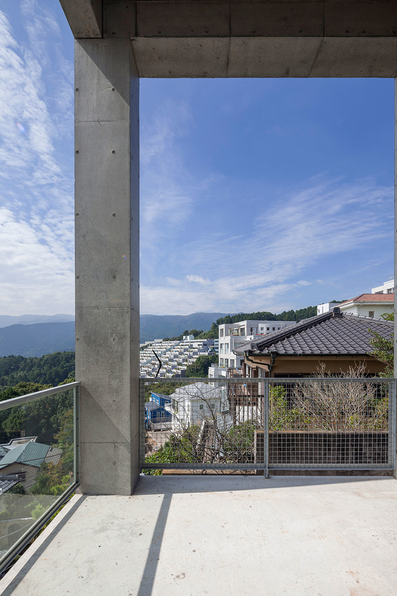 ashida architects sets concrete atami tower house on a steep slope in japan