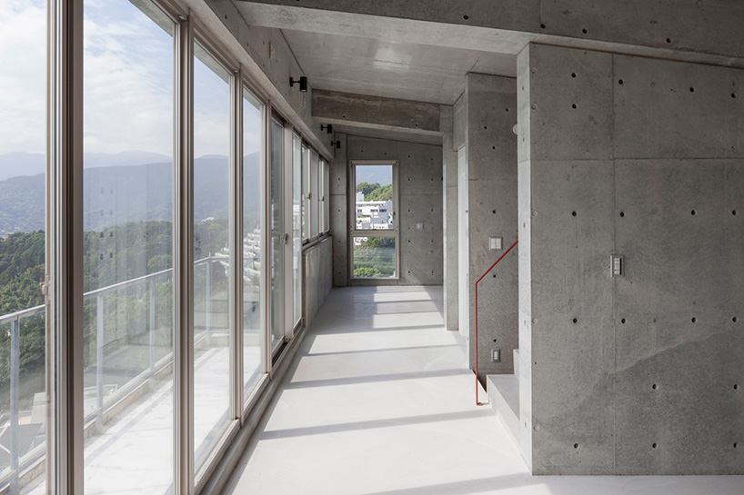 ashida architects sets concrete atami tower house on a steep slope in japan