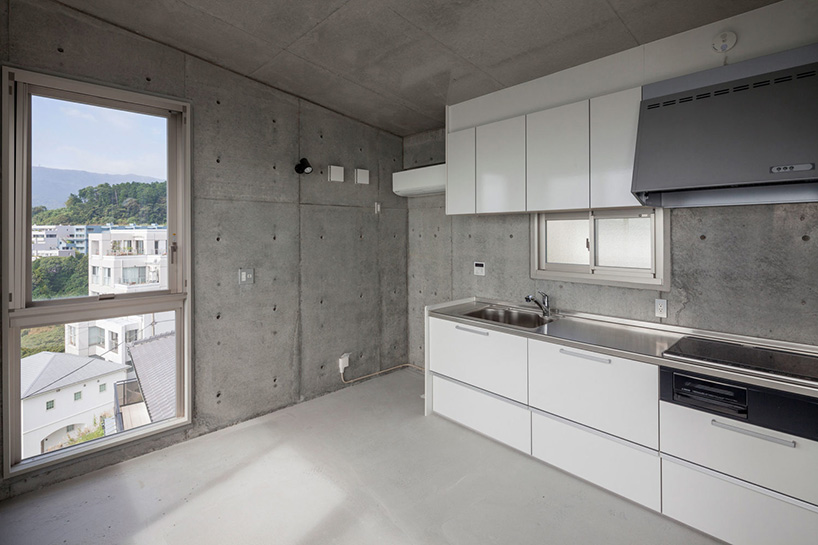 ashida architects sets concrete atami tower house on a steep slope in japan